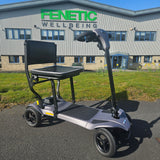 Electric scooter on a driveway with a building in the background