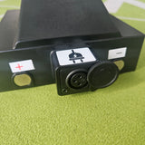 Black battery with connectors on a green textured surface