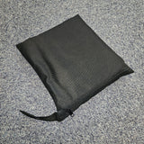 Black zip bag on a grey textured surface