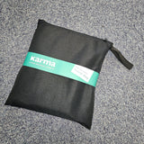 Black pouch with a green 'karma' label on a gray textured surface