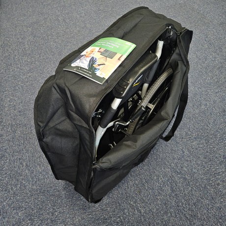 Black duffel bag with a folded chair inside on a gray surface