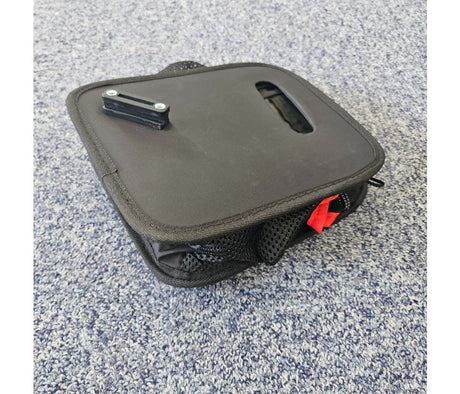 Black rollator bag on a textured gray surface