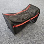 Black and red bag on a gray surface
