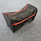 Black and red bag on a gray surface