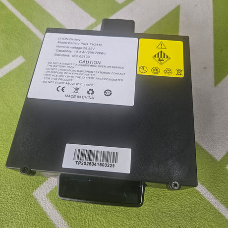 Black battery pack with labels on a green background