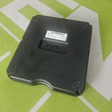 Black electronic device on a green surface