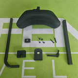Black metal wheelchair components on a green surface with white lines