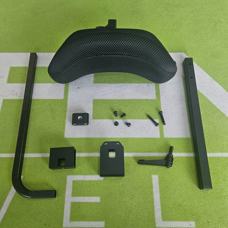 Black metal wheelchair components on a green surface with white lines
