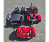 Red and black mobility scooter on a gray pavement