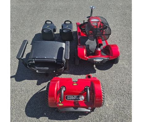 Red and black mobility scooter on a gray pavement